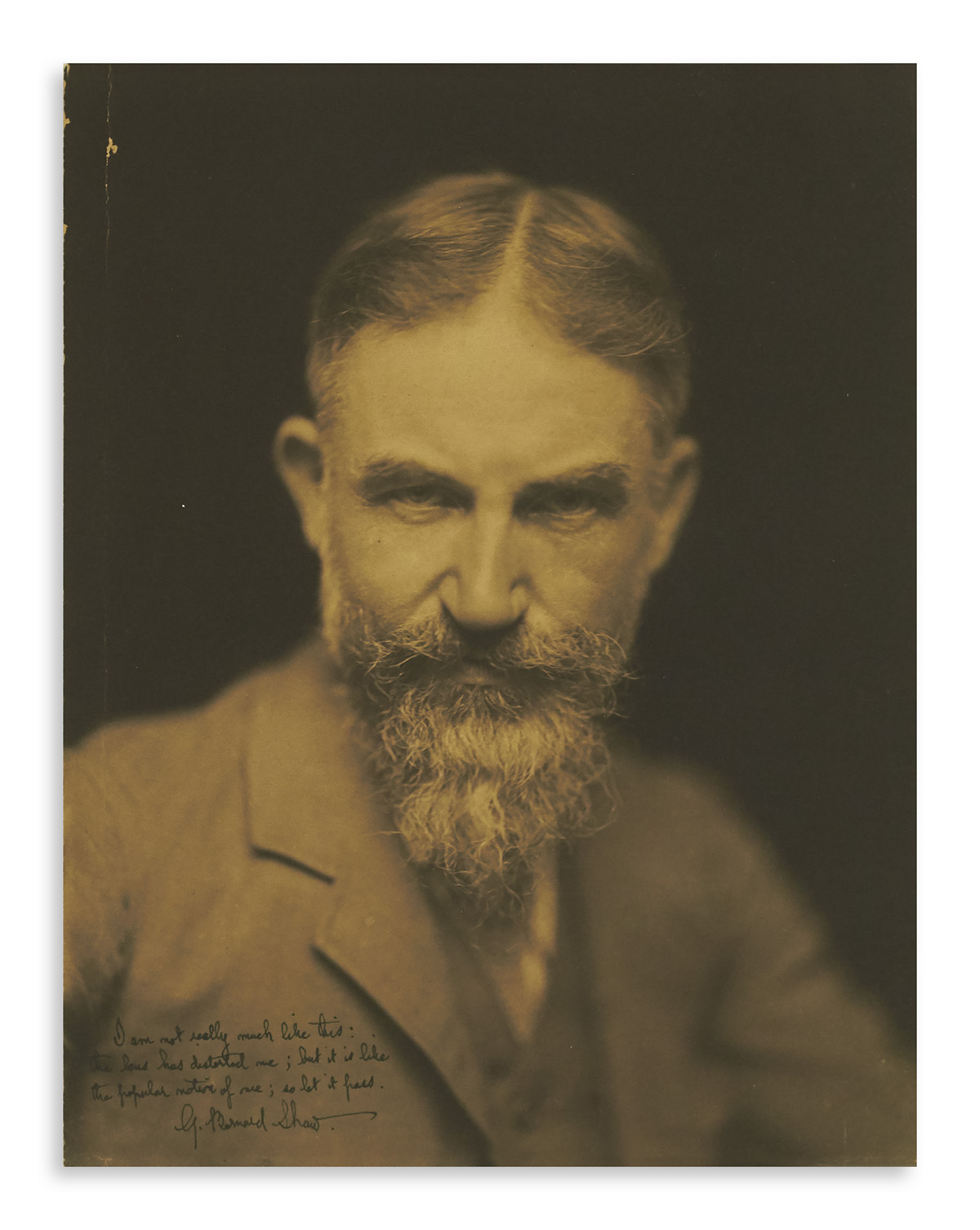 SHAW, GEORGE BERNARD. Photograph Signed and Inscribed, I am not really much like this: / the lens has distorted me; but it is like / t